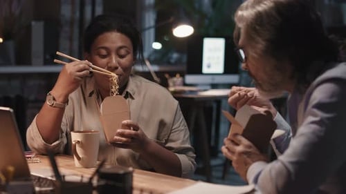 Colleagues Eating Noodles At Night