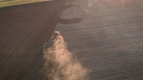 Aerial View Modern Red Tractor on the Agricultural Field on Sunset Time, Tractor Plowing Land
