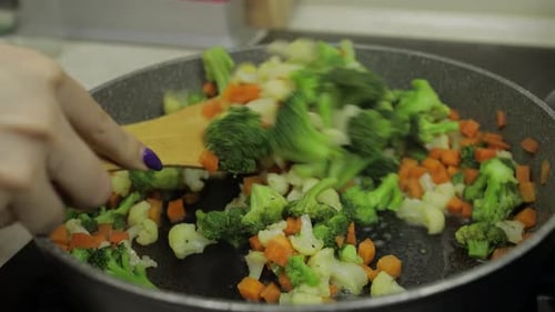 Mixing Fresh Vegetables on Frying Pan. Boiling Carrots, Cauliflower, Broccoli