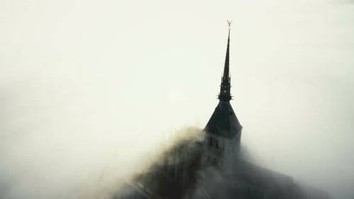 Drone Flying Around Beautiful Sunny Gothic Abbey Building on Top of Mont Saint Michel Island Under