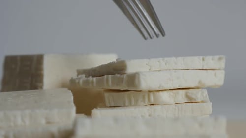 Taking cow milk cheese with fork slow-mo video
