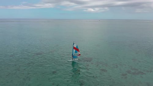 Aerial View of Windsurfer Surfing in in Calm Deep Blue of Sea Extreme Summer Sport Activity