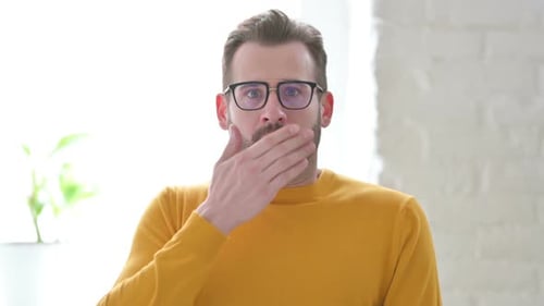 Man Reacts with Surprise and Confusion Indoors