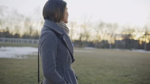 Woman in Autumn Coat Walking Outdoors in Park