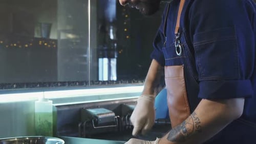 Handsome Bearded Chef Cooking on the Kitchen of a Restaurant