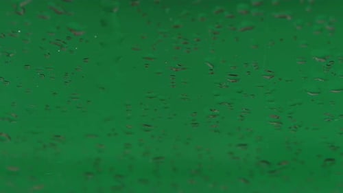 Raindrops on glass. Green screen background.
