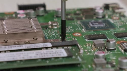 Close-up of Technician Repairing Laptop at Desk. Computer Repair.