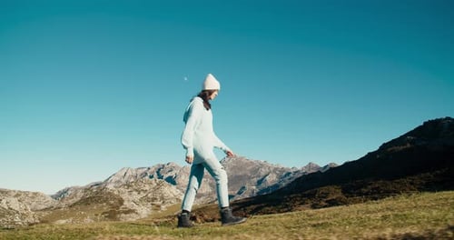 Excited Young Adult Woman Walk on Top of Hill with Mountain View