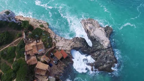 Aerial View of Waves Crashing on Rocky Coastline