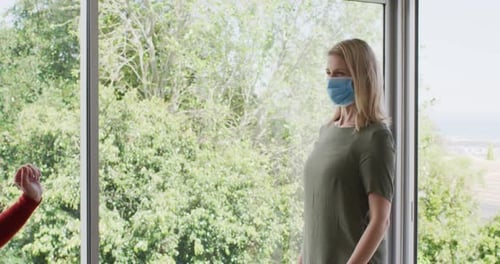 Elbow Bump Greeting Between Two Masked Adults