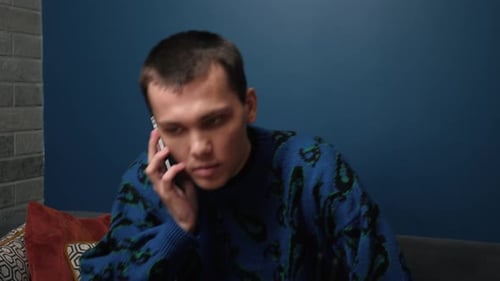 Young Adult Talking on the Phone Indoors
