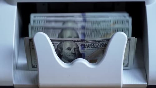 Money Counter Processes Stacks of Hundred Dollar Bills