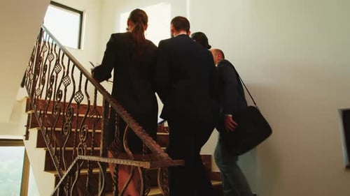 Businesspeople walking up modern building staircase