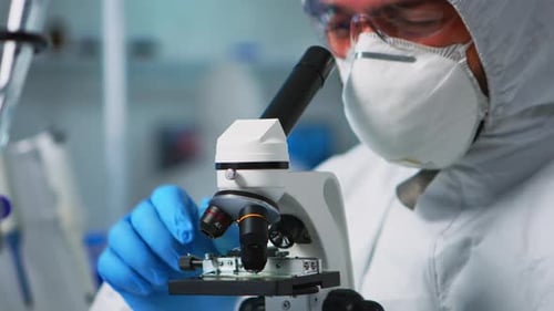 Close Up of Chemist Doctor Analysing Virus Using Microscope