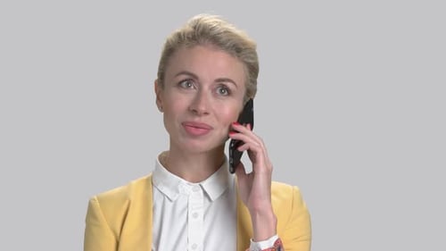 Woman Talking on Cell Phone with Yellow Jacket