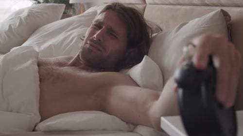 Man Wakes Up in Bright Bedroom