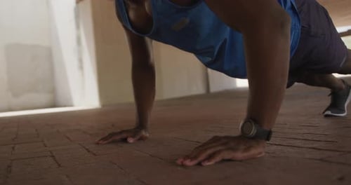 Man Doing Pushups for Exercise in Urban Setting