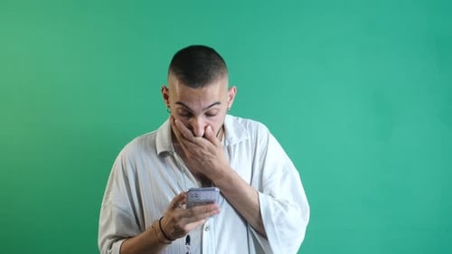 Shocked Man Reacts to Phone on Green Screen