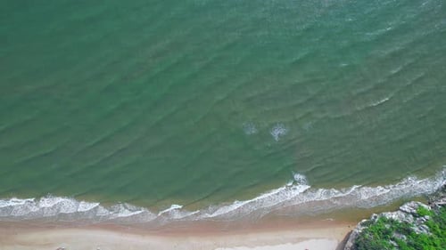 4K Aerial view top view of drone, sea waves and beautiful sand beach.