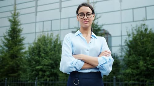 Confident Businesswoman Stands Proudly Near Office Building
