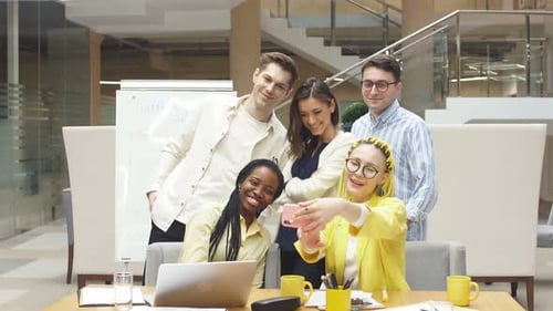 Smiling Team Poses for a Selfie in Office