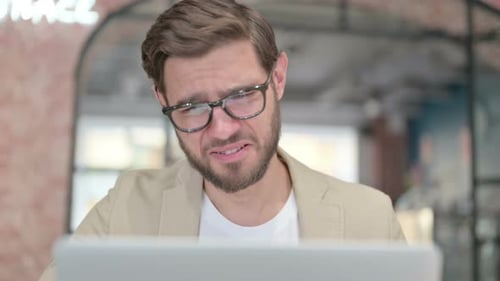Close Up of Man with Laptop Having Loss Failure
