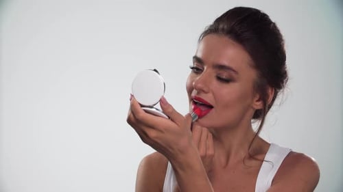 Woman Applying Bright Red Lipstick, Close Up