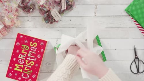 Time lapse. Flat lay. Step by step. Packaging homemade fudge and cookies into a Christmas gift box.
