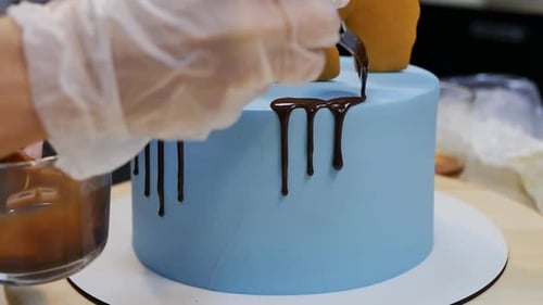 Pastry Chef Decorates Birthday Cake with Chocolate Sauce