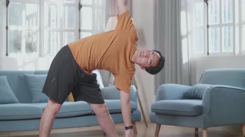 Man Doing Yoga Exercise at Home on Mat