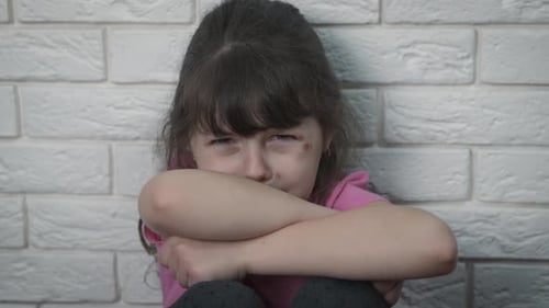 A Depressed Child Cries. Child Abuse.