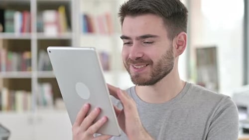 Young Adult Using a Tablet Device Indoors