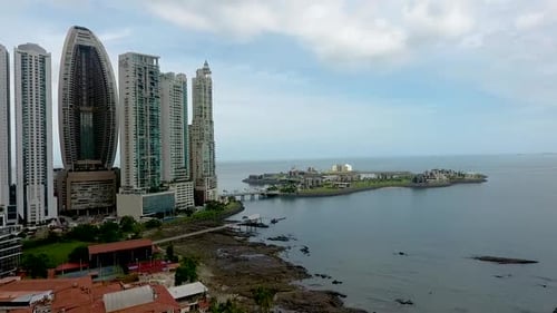 Aerial drone footage of famous building in Panama City in front of an artificial island