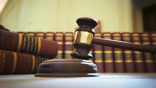 Hardwood gavel hitting sound block in court of law. Symbol of justice, judgement