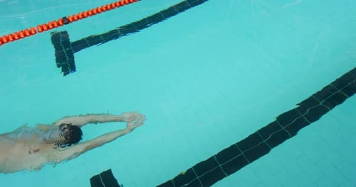 Swimmer swimming into the pool