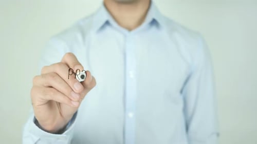 Man Writes Product Development on Clear Screen