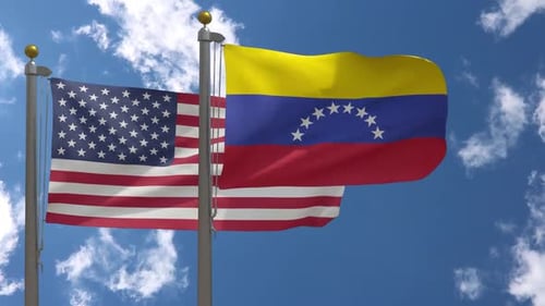 United States and Venezuela Flags Waving Against Blue Sky