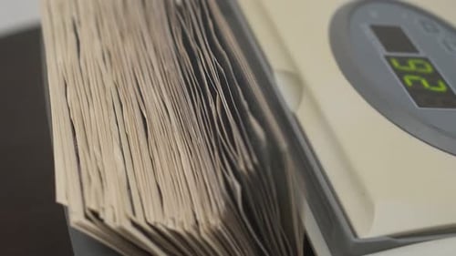 Money Counting Machine Takes Bills Out of the Stack By Counting Hundreddollar Bills Closeup of the