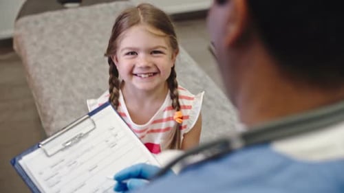 Smiling Child at Medical Checkup with Doctor