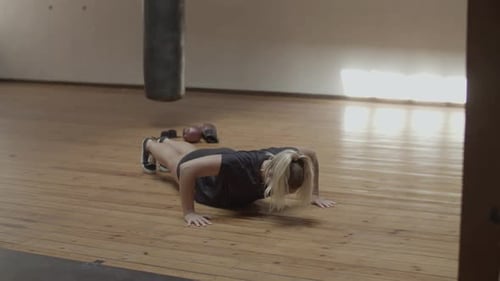 Fit Woman Doing Push Ups in Gym
