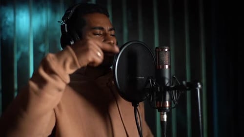 Closeup Face of African American Man Artist Reading Rap in Microphone During Recording Hip Hop Song