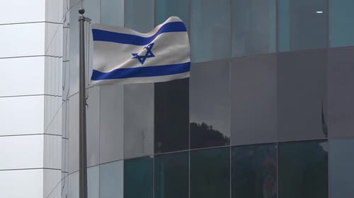 Realistic Israel Flag Waving on Pole in Front of Modern Building
