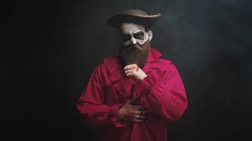 Bearded Man with Skull Makeup Posing in Studio