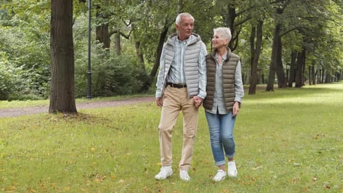 Loving Senior Couple Walks in the Park