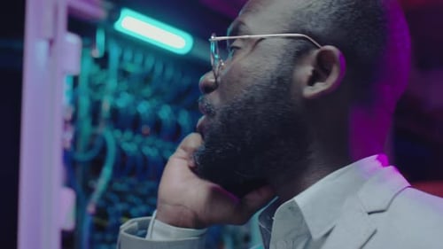 Data Center Engineer Speaking on Phone at Work