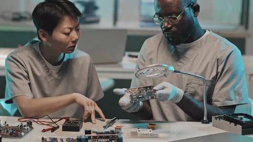 Diverse Engineers Discussing Computer Hardware in Lab