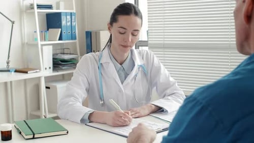 Female Doctor Consults Patient in Bright Office