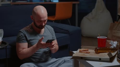 Worried Tenant By Receving Notification on Smartphone for Unpaid Invoices