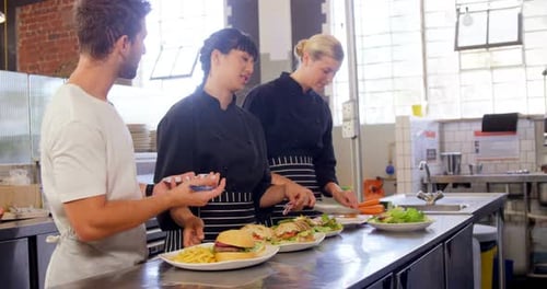 Chefs Prepare Food Orders in Restaurant Kitchen
