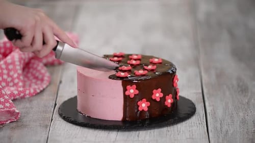 Knife Cutting Delicious Cake With Pink Flowers